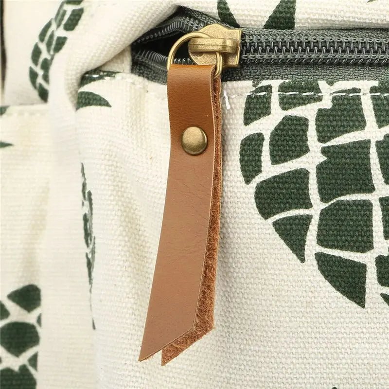 Sac à dos en toile crème avec motif ananas vert foncé et tirette en cuir brun