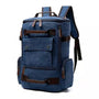 Sac à dos homme casual en toile navy bleu avec accents en cuir marron et compartiments zippés