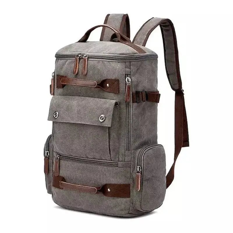 Sac à dos en toile grise avec accents en cuir marron et plusieurs compartiments
