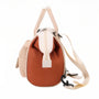Mini sac à dos Plume Claire en cuir marron avec zip blanc et sangle