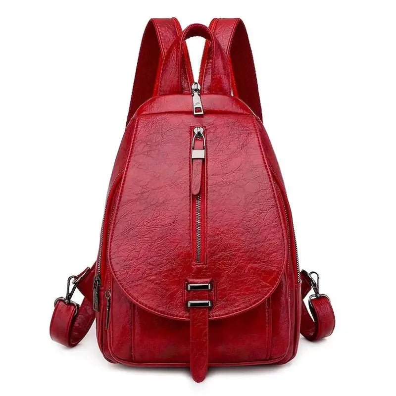 Sac à dos femme en cuir rouge brillant avec zippers et boucles pour un style tendance