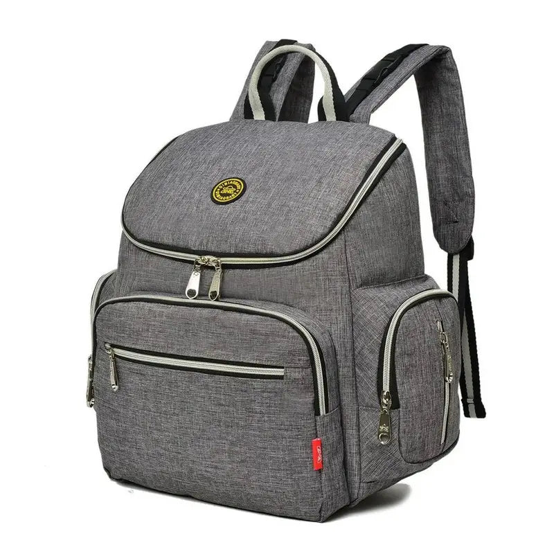 Sac à dos à langer gris en tissu avec plusieurs compartiments zippés et bretelles rayées noir et blanc