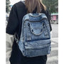 Sac à dos ado fille tendance en denim lavé avec multiples poches zippées et poignée supérieure