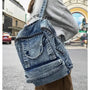 Sac à dos ado fille tendance en denim acid-wash avec zippers noirs et multiples poches