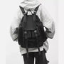 Sac à dos baroudeur homme en tissu noir avec boucles et multiples poches