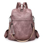 Sac à dos cuir souple violet en faux cuir avec poches extérieures et pompon doré