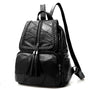 Sac à dos de ville en similicuir noir avec broderie tressée et zips à pompons