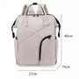 Sac à dos à langer chic gris clair avec multiples poches et accents noirs