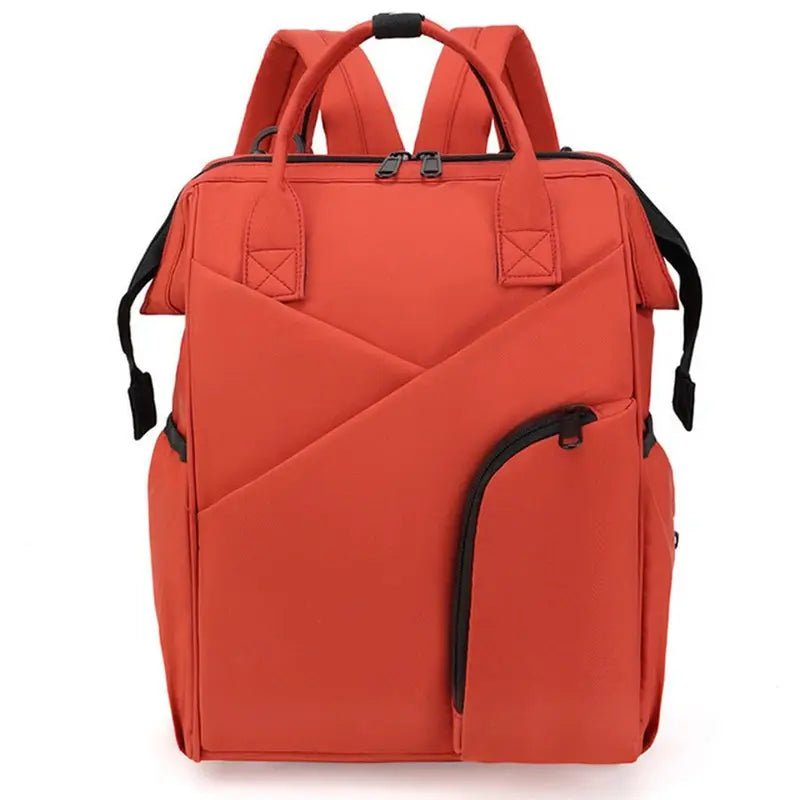 Sac à dos à langer chic orange avec plusieurs poches et accents noirs