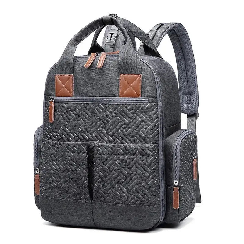 Sac à dos sac à langer gris foncé matelassé avec accents en cuir marron