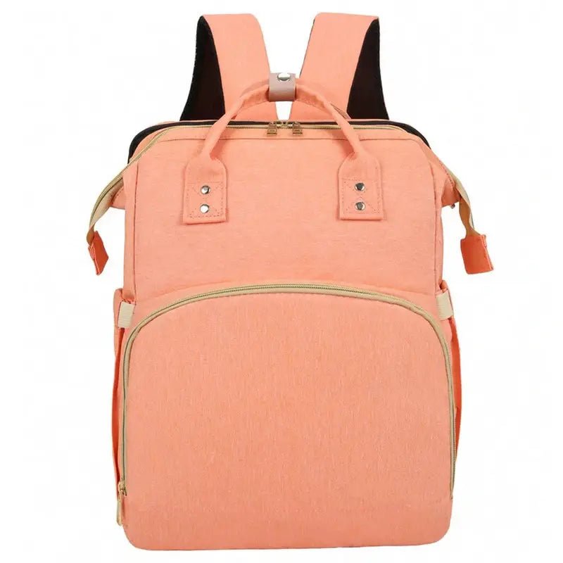 Sac à dos à langer lit en peach avec poignées supérieures et bretelles d’épaule