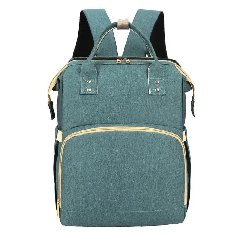Sac à dos à langer lit en turquoise avec accents beige et zips dorés