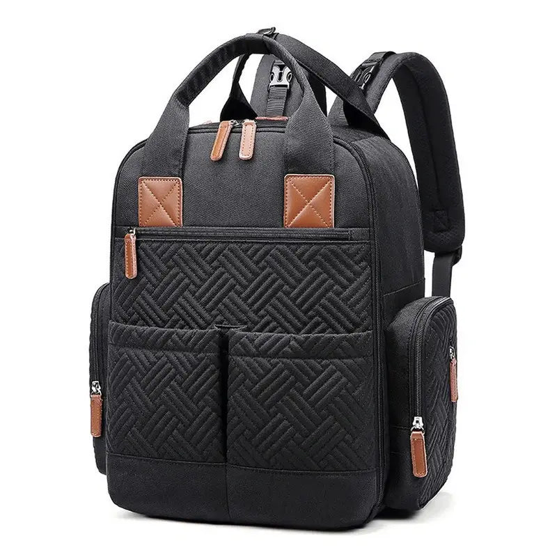 Sac à dos sac à langer noir en quilting avec accents en cuir marron et multiples poches