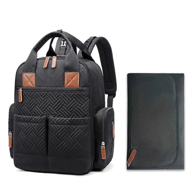 Sac à dos sac à langer noir matelassé avec accents en faux cuir marron et tapis à langer assorti