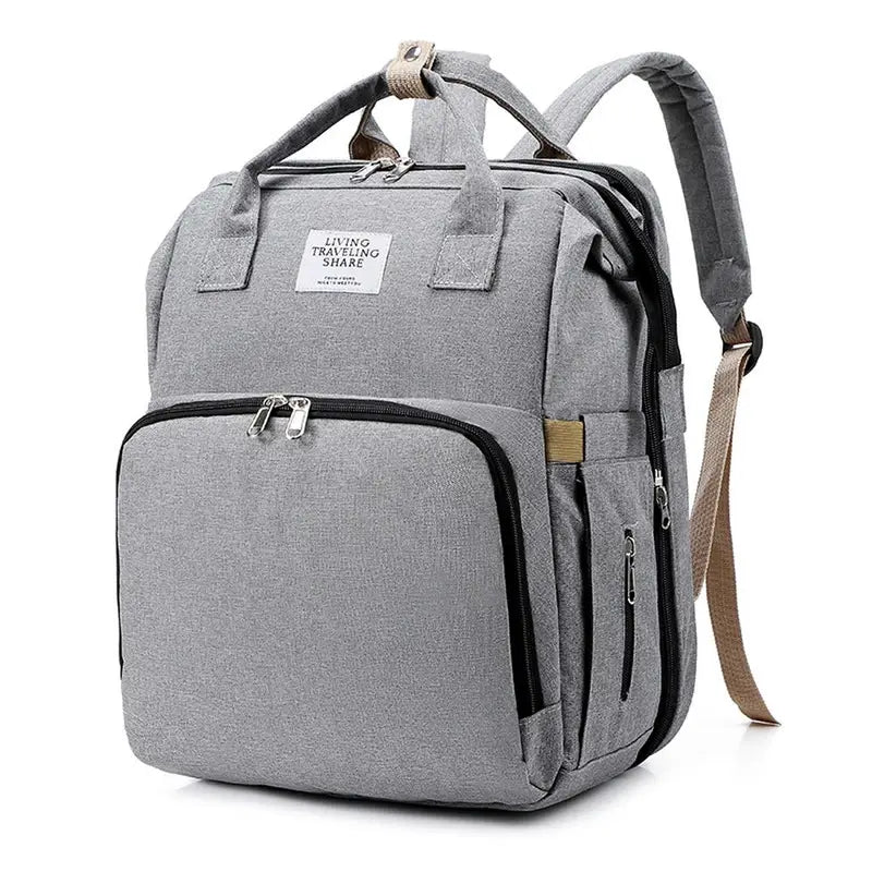 Sac à dos à langer USB en toile gris clair avec plusieurs compartiments et poignée supérieure