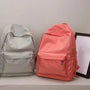 Sac à dos petite fille en nylon gris clair et pêche avec poches frontales zippées