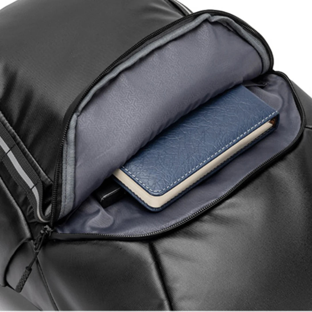 Sac à dos roll top Kingsons Black Edition ouvert avec un carnet bleu dans la poche rembourrée