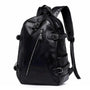Sac à dos urbain pour femme en cuir noir avec multiples zippers et boucles