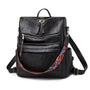 Sac à dos vintage femme en similicuir noir avec fermetures dorées et sangle géométrique colorée