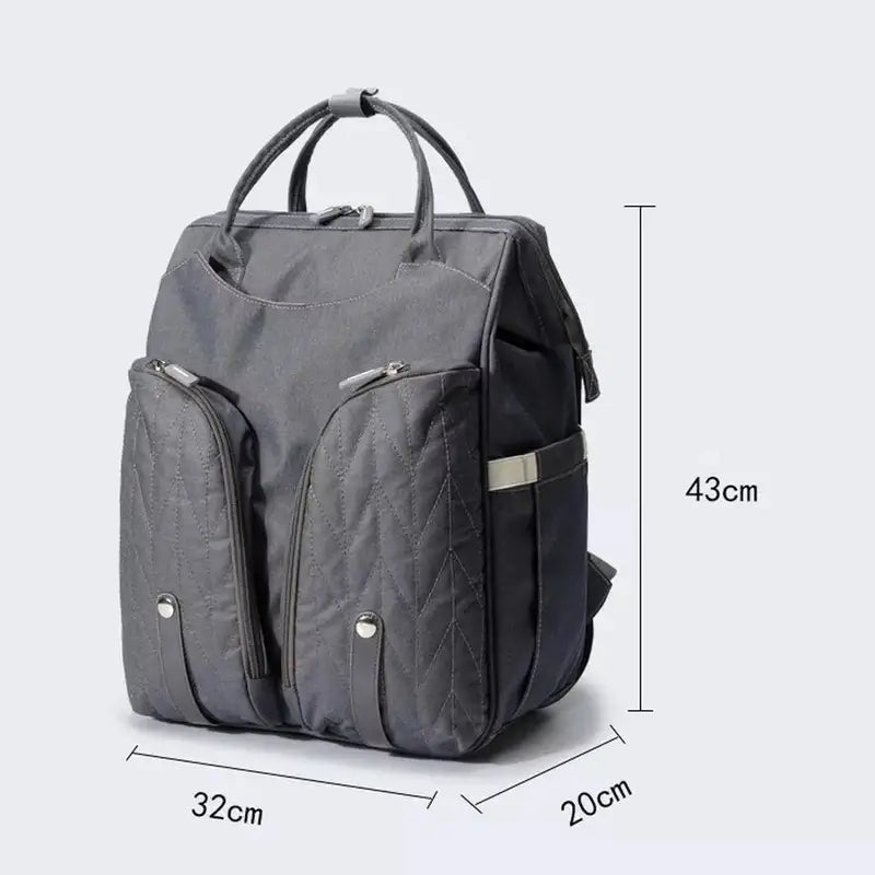 Sac à langer sac à dos gris en tissu avec poches zippées et poignées de transport